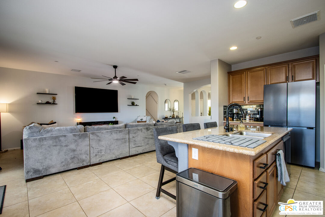 56166 Nez Perce Trail Yucca Valley, CA 92284 - Photo 10 of 54 a kitchen with stainless steel appliances granite countertop a sink a stove a refrigerator cabinets and chairs