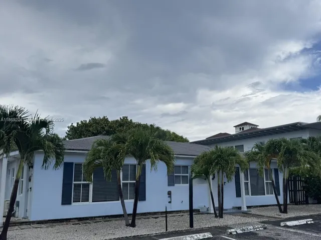 a front view of house with a garden