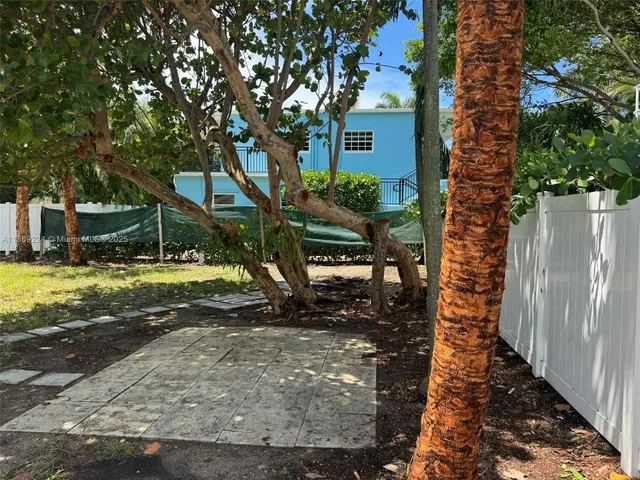 a view of a house with backyard porch and sitting area