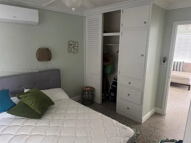 a bedroom with furniture and a window