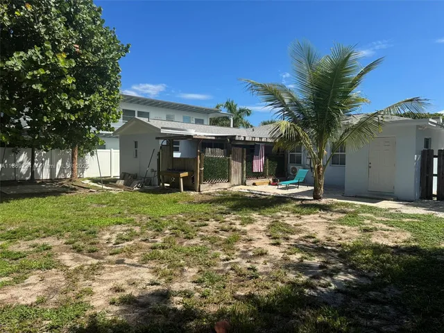 a view of a house with a tree tree and a yard