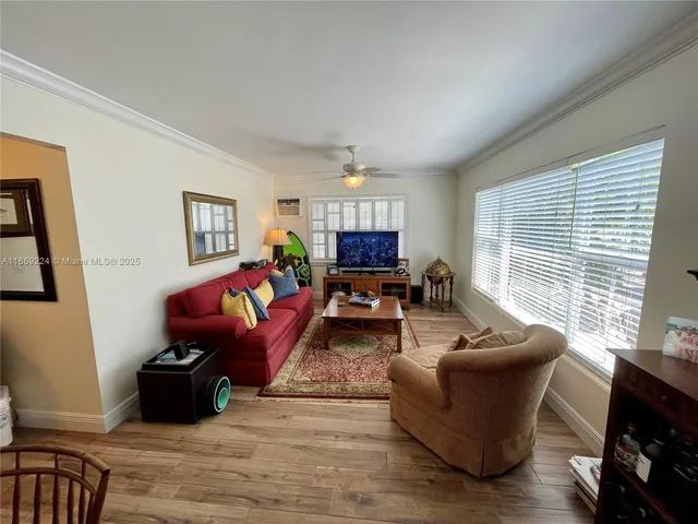 a living room with furniture windows and a flat screen tv