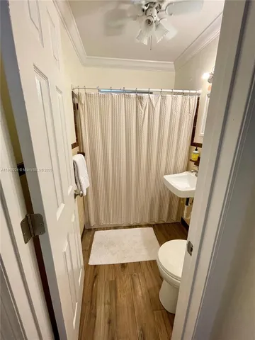 a white toilet sitting next to a sink and a shower
