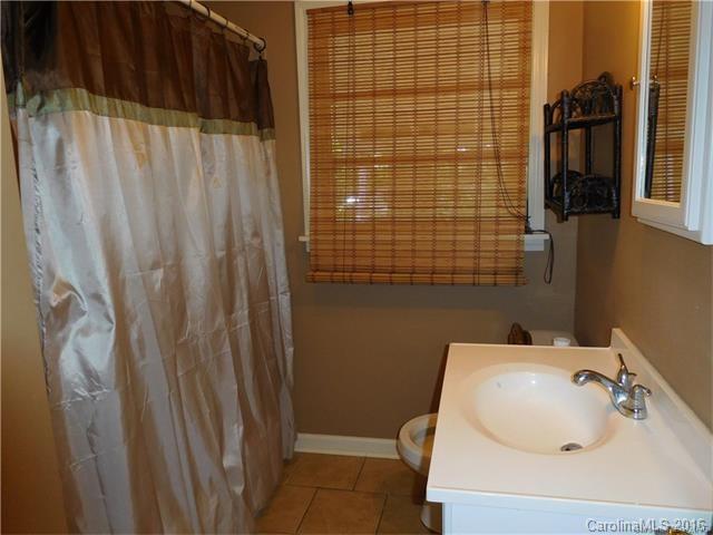 1980 Troutman Hill Road Kannapolis, NC 28083 - Photo 6 of 12 a bathroom with a sink a toilet and shower curtain