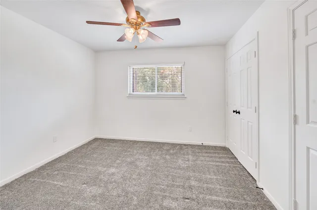 a bathroom with a granite countertop double vanity sink and a mirror