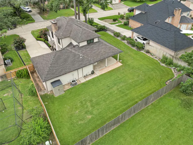 an aerial view of a house with a yard