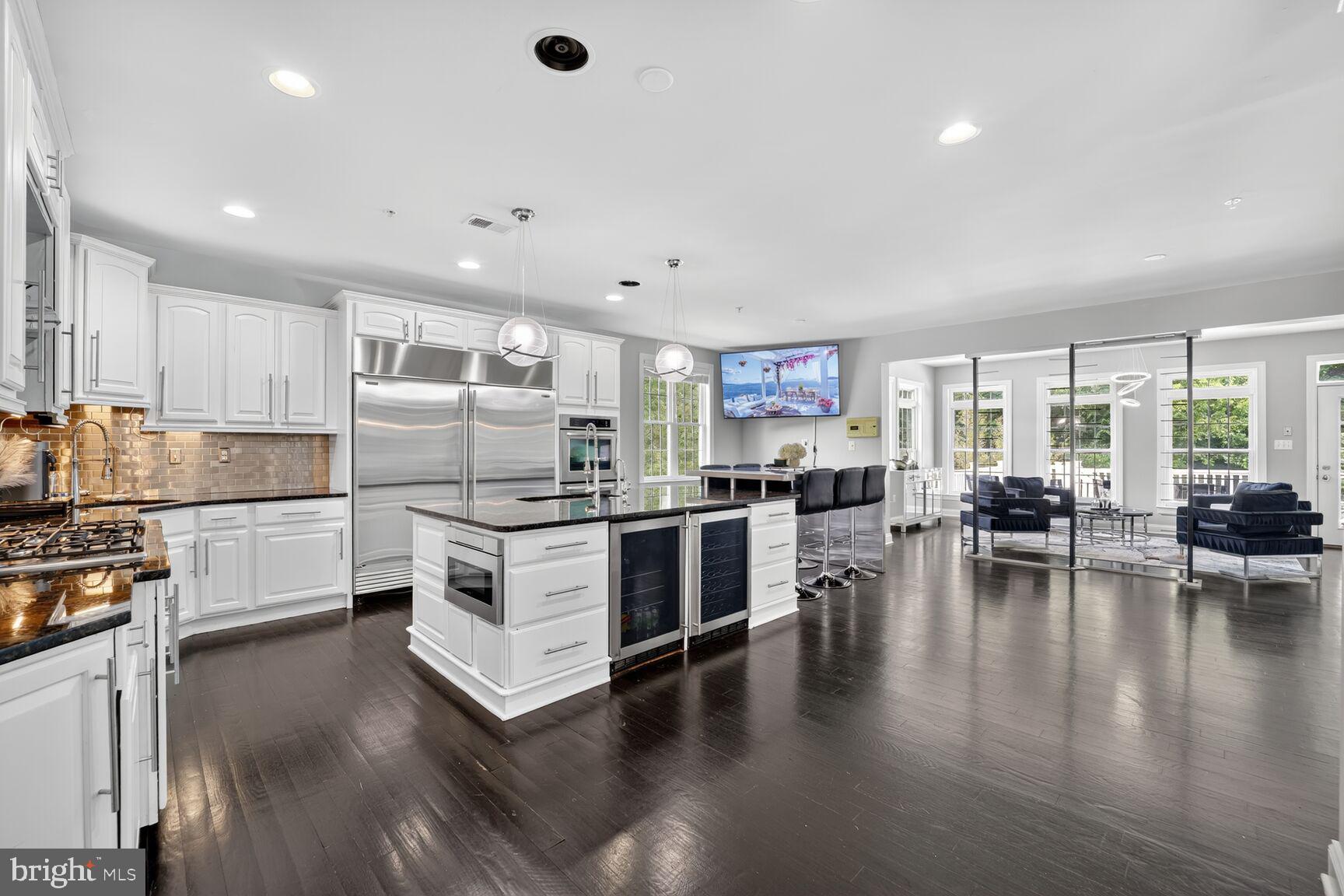 16831 Swanson Road Upper Marlboro, MD 20774 - Photo 15 of 56 a kitchen with white cabinets and stainless steel appliances