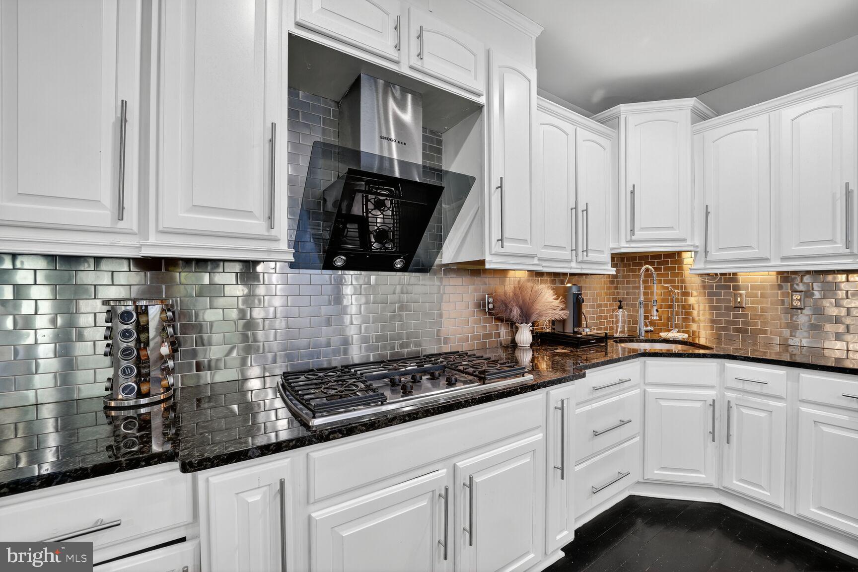 16831 Swanson Road Upper Marlboro, MD 20774 - Photo 16 of 56 a kitchen with white cabinets and white appliances