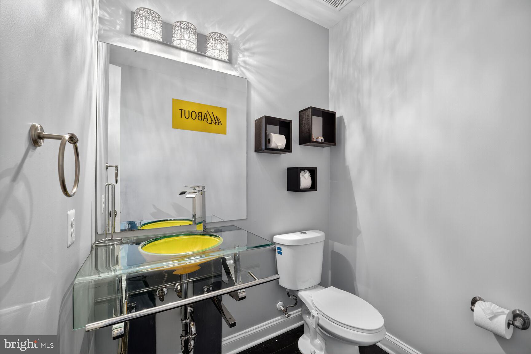 16831 Swanson Road Upper Marlboro, MD 20774 - Photo 26 of 56 a bathroom with a sink mirror vanity and toilet