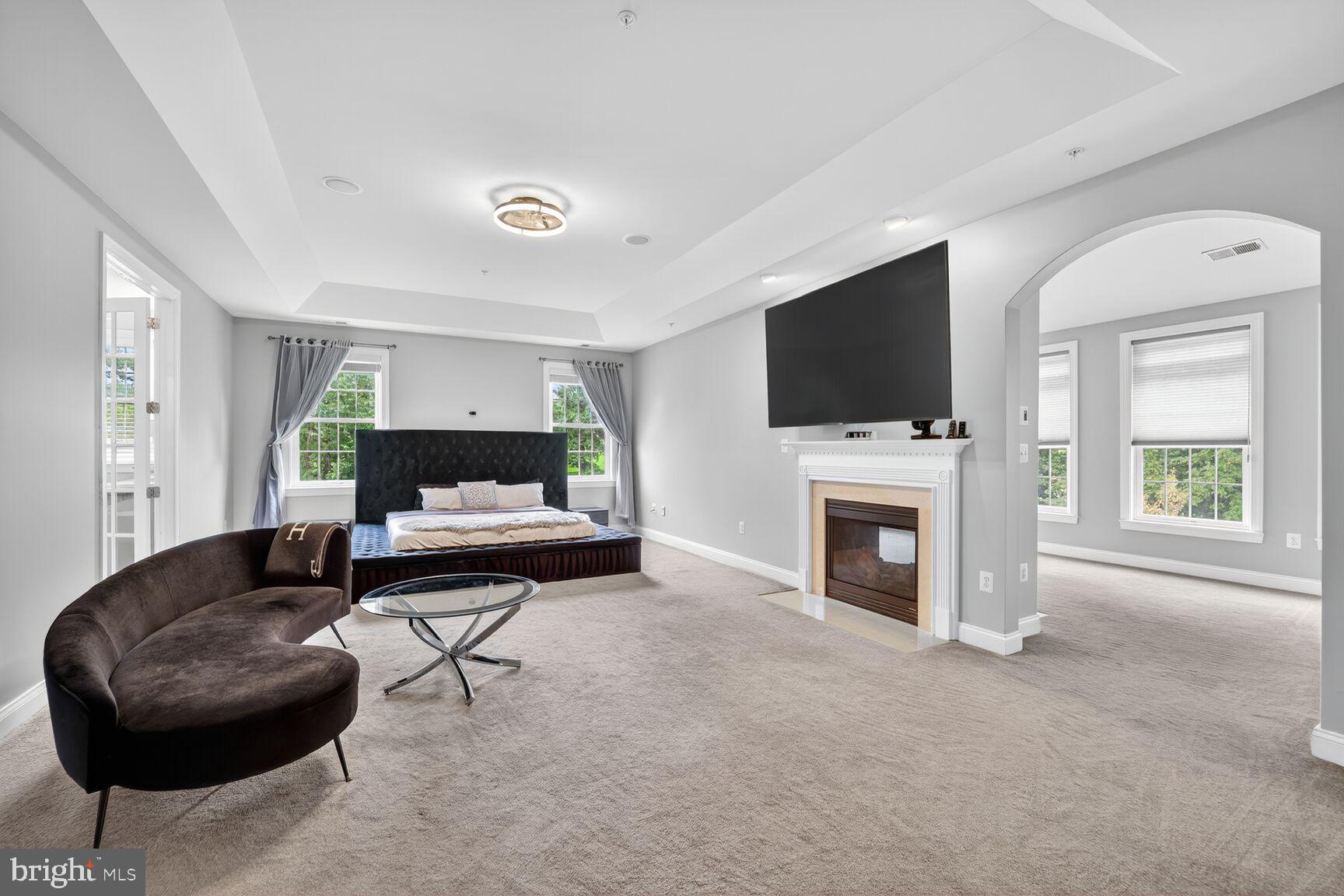 16831 Swanson Road Upper Marlboro, MD 20774 - Photo 29 of 56 a living room with furniture a fireplace and a flat screen tv
