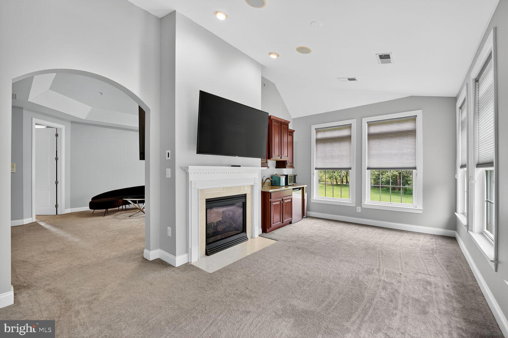 16831 Swanson Road Upper Marlboro, MD 20774 - Photo 30 of 56 a view of a livingroom with a fireplace a flat screen tv and a window