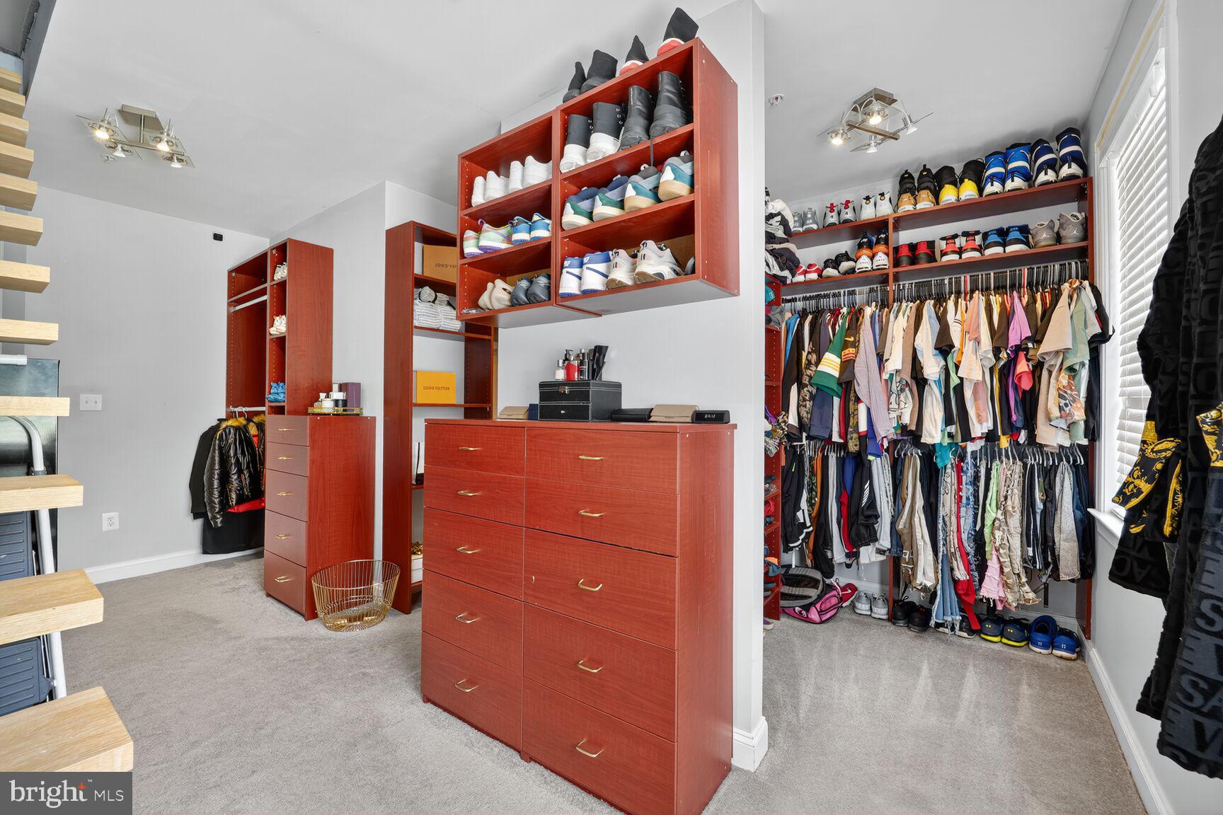 16831 Swanson Road Upper Marlboro, MD 20774 - Photo 34 of 56 walk in closet with clothes and shoes