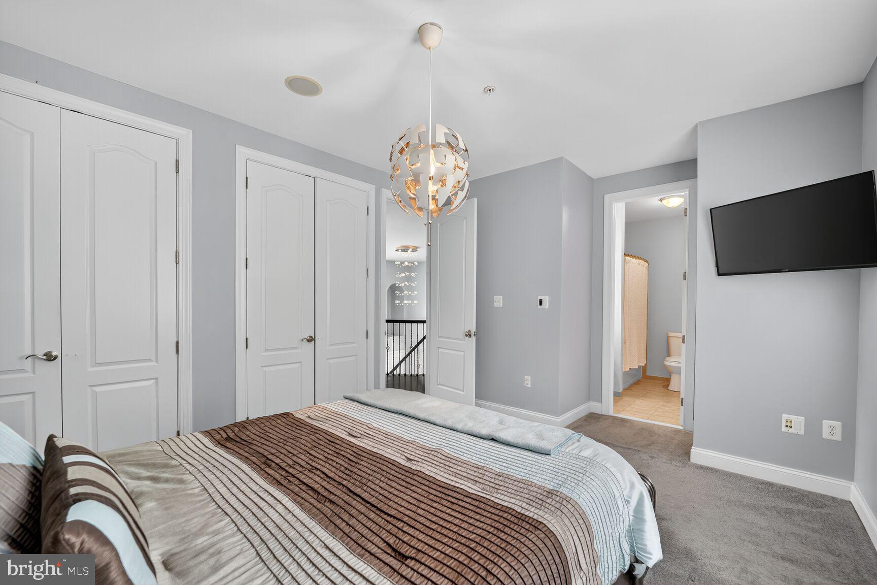 16831 Swanson Road Upper Marlboro, MD 20774 - Photo 37 of 56 a bedroom with bed and a chandelier