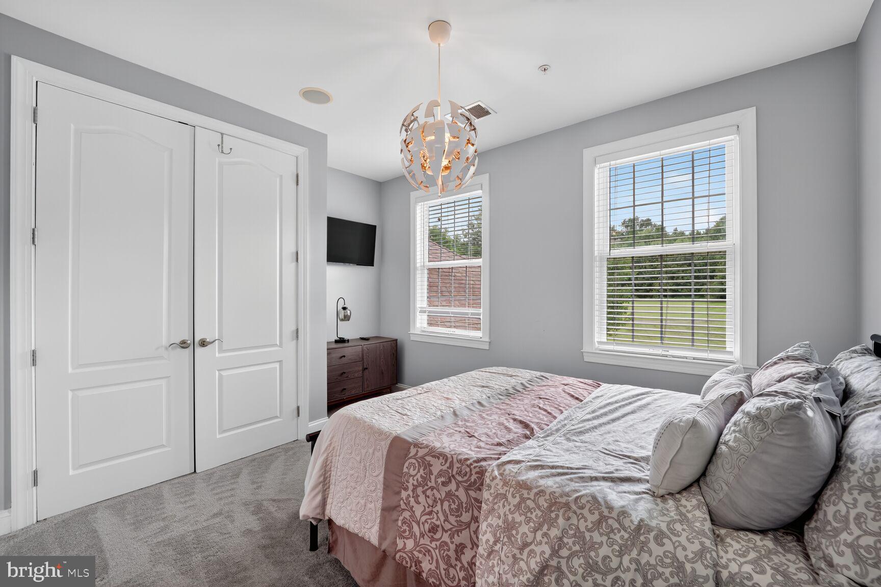 16831 Swanson Road Upper Marlboro, MD 20774 - Photo 38 of 56 a bedroom with a bed and a chandelier