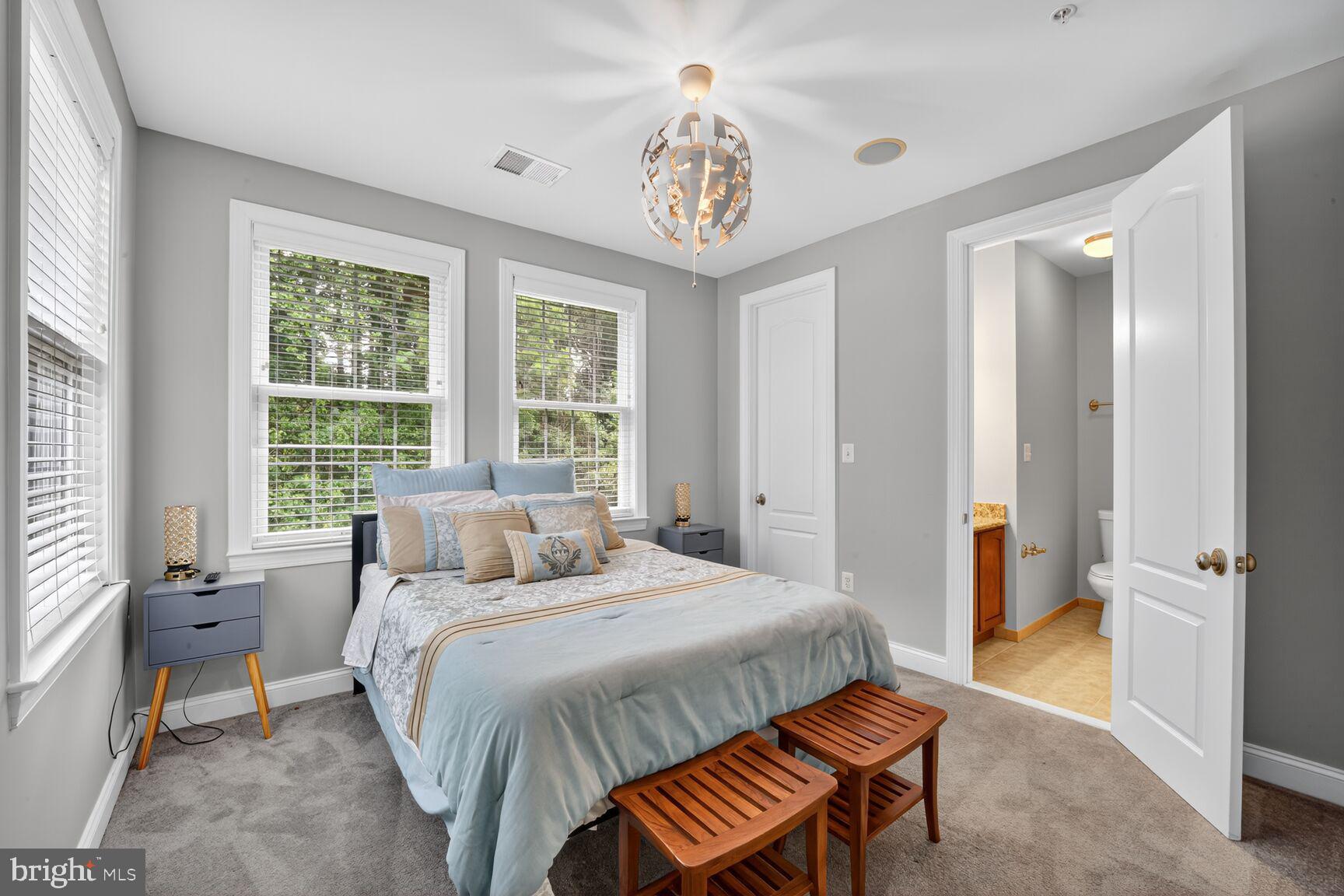 16831 Swanson Road Upper Marlboro, MD 20774 - Photo 41 of 56 a bedroom with a bed and a chandelier