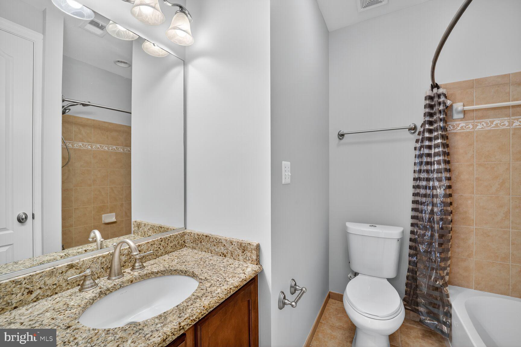16831 Swanson Road Upper Marlboro, MD 20774 - Photo 42 of 56 a bathroom with a granite countertop sink toilet and shower