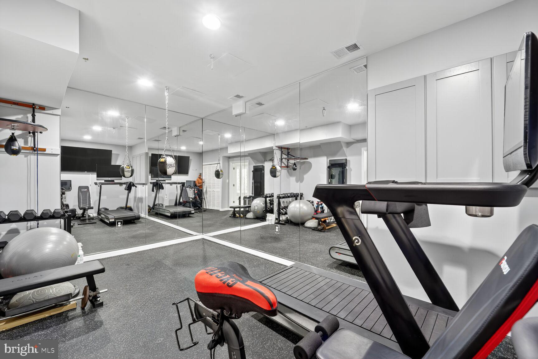 16831 Swanson Road Upper Marlboro, MD 20774 - Photo 49 of 56 a room with gym equipment and a table