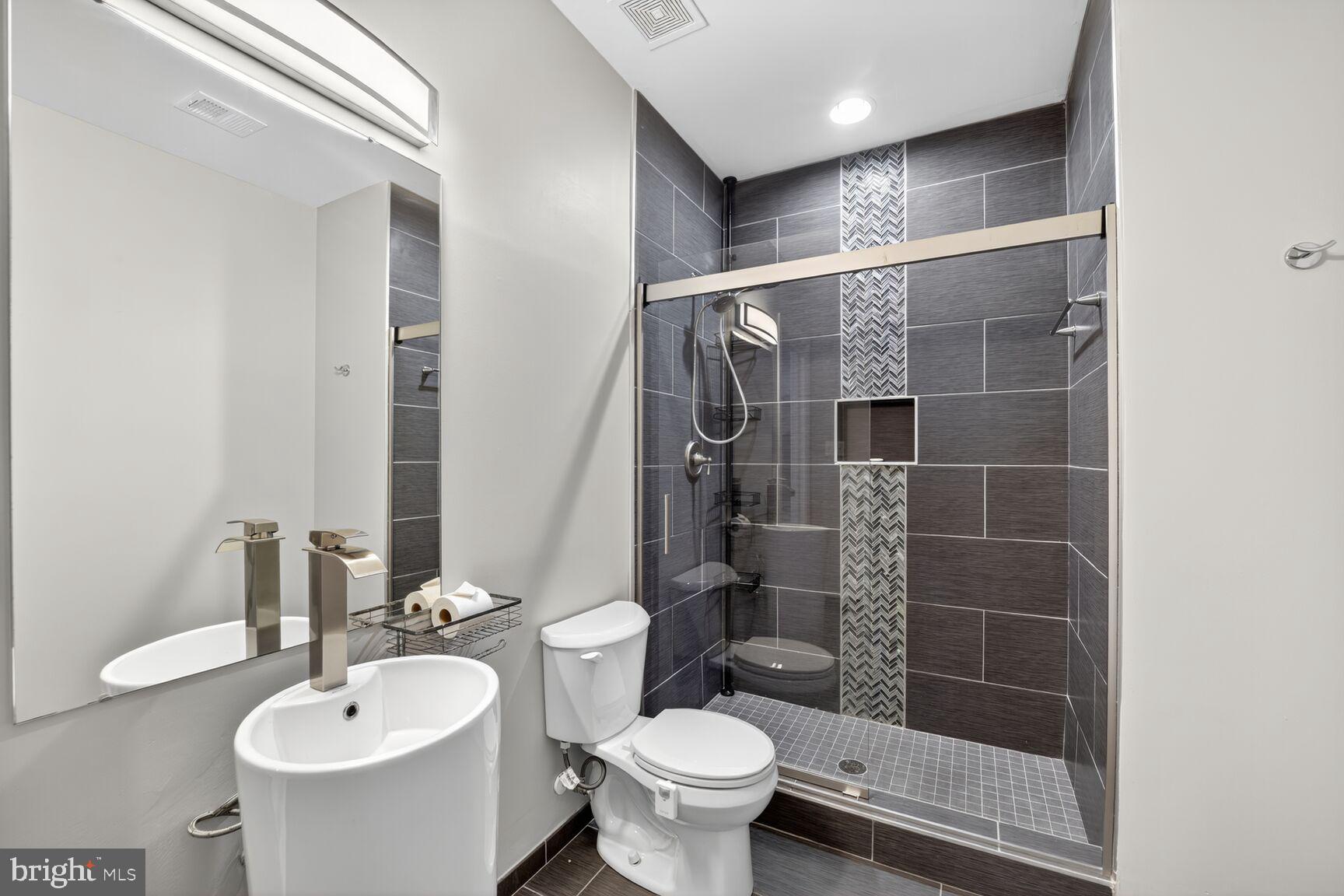 16831 Swanson Road Upper Marlboro, MD 20774 - Photo 50 of 56 a bathroom with a toilet sink and shower