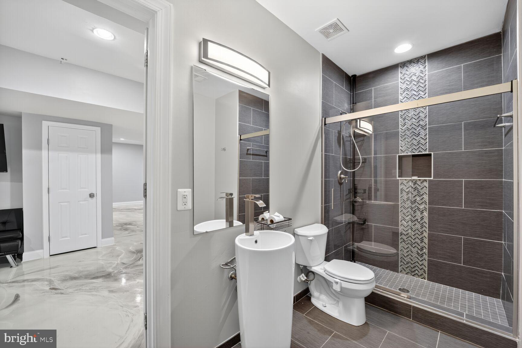16831 Swanson Road Upper Marlboro, MD 20774 - Photo 51 of 56 a bathroom with a toilet sink and shower