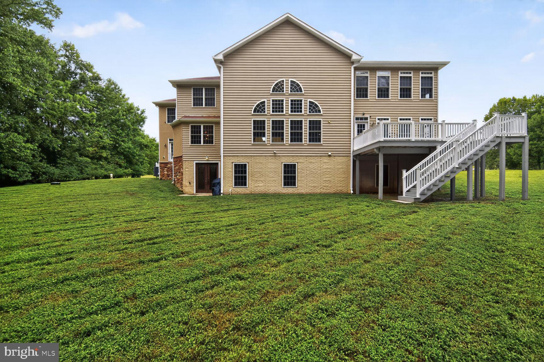 16831 Swanson Road Upper Marlboro, MD 20774 - Photo 55 of 56 a front view of a house with a yard and trees