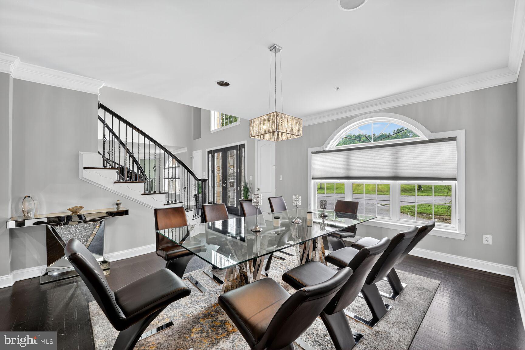 16831 Swanson Road Upper Marlboro, MD 20774 - Photo 10 of 56 a view of a livingroom and dining room with furniture wooden floor a chandelier