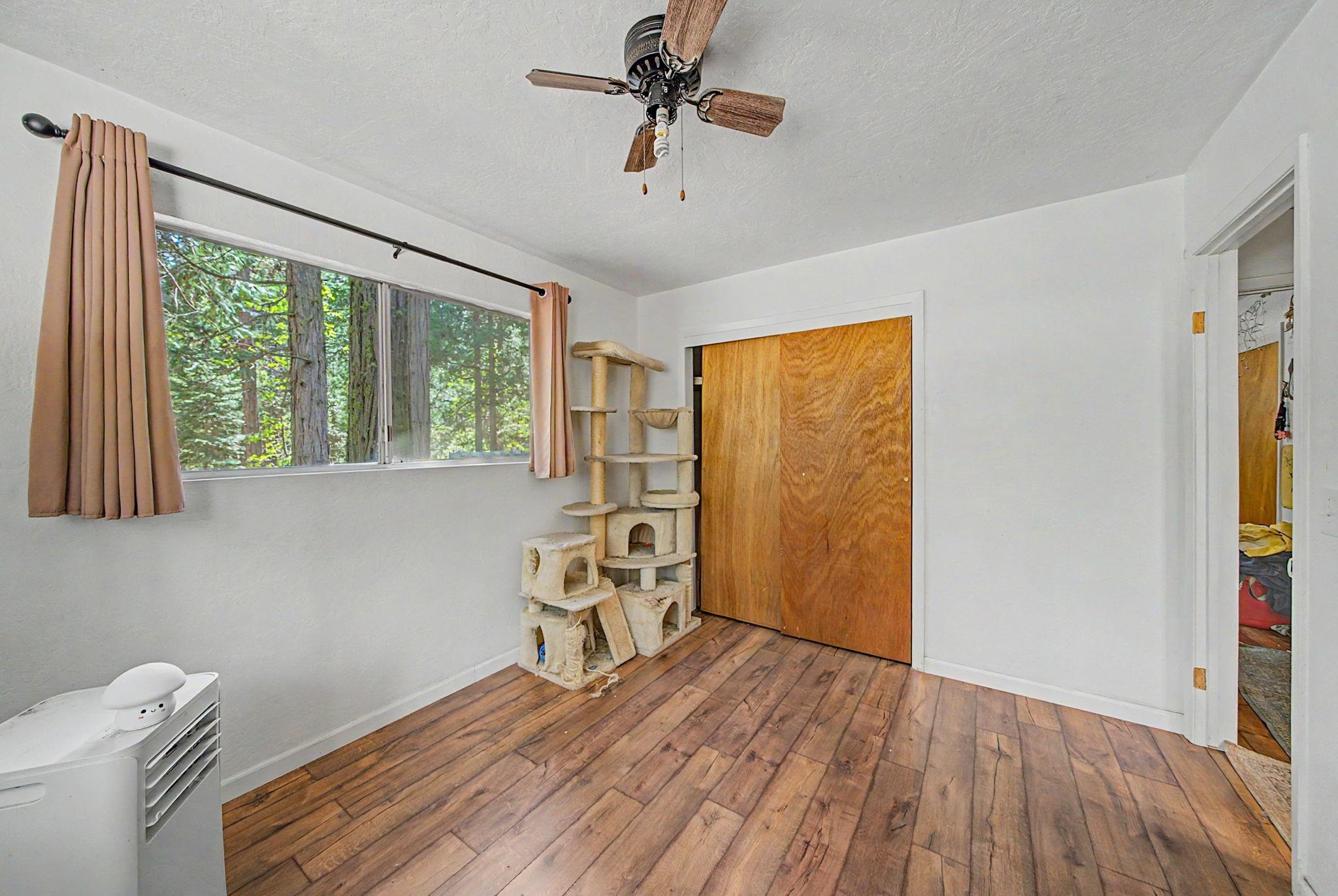 58374 Gill Ranch Road Cromberg, CA 96103 - Photo 30 of 44 a view of a livingroom with wooden floor and a ceiling fan