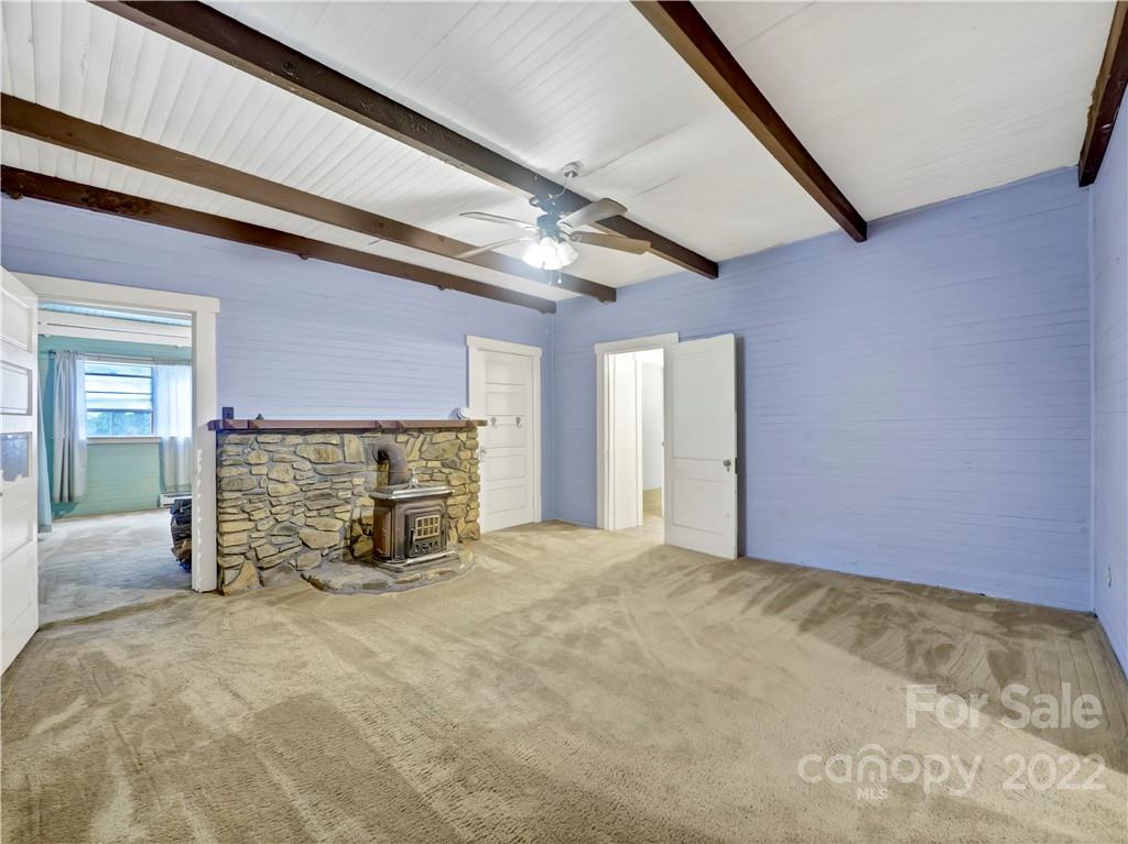 2731 Redmon Road Marshall, NC 28753 - Photo 12 of 43 a view of an empty room with a fireplace and a window