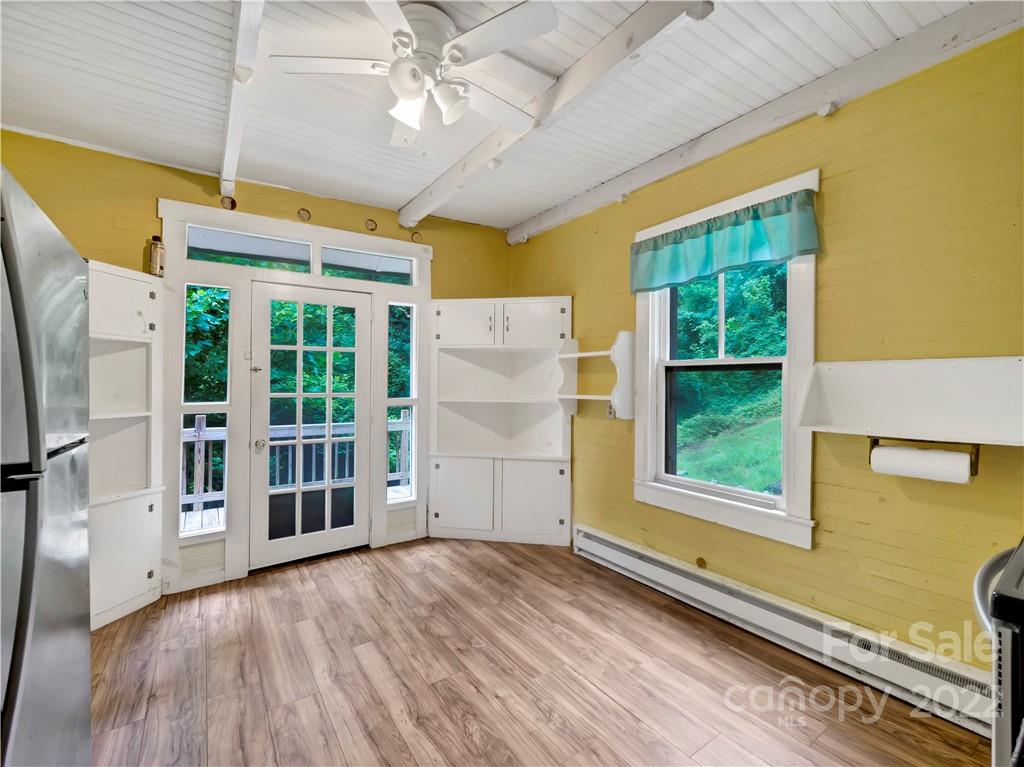 2731 Redmon Road Marshall, NC 28753 - Photo 21 of 43 a view of a livingroom with wooden floor and a ceiling fan