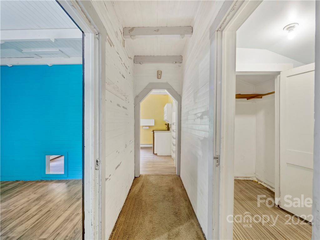 2731 Redmon Road Marshall, NC 28753 - Photo 28 of 43 a view of a hallway with wooden floor and a bathroom