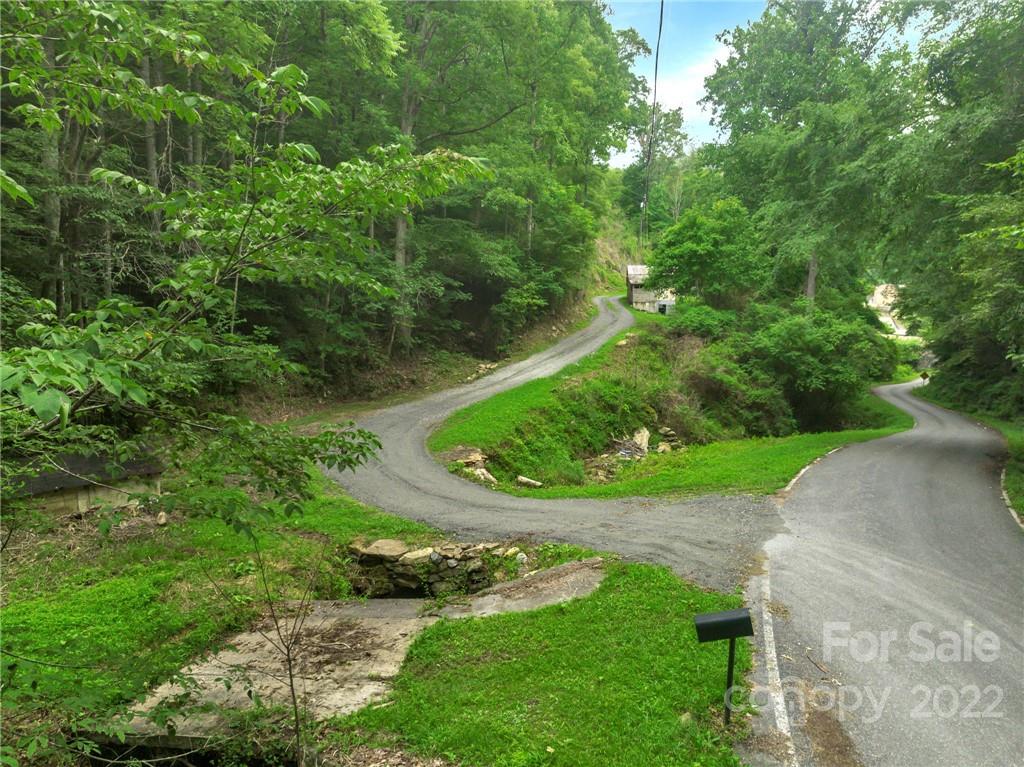 2731 Redmon Road Marshall, NC 28753 - Photo 41 of 43 an aerial view of green landscape with trees houses and mountain view