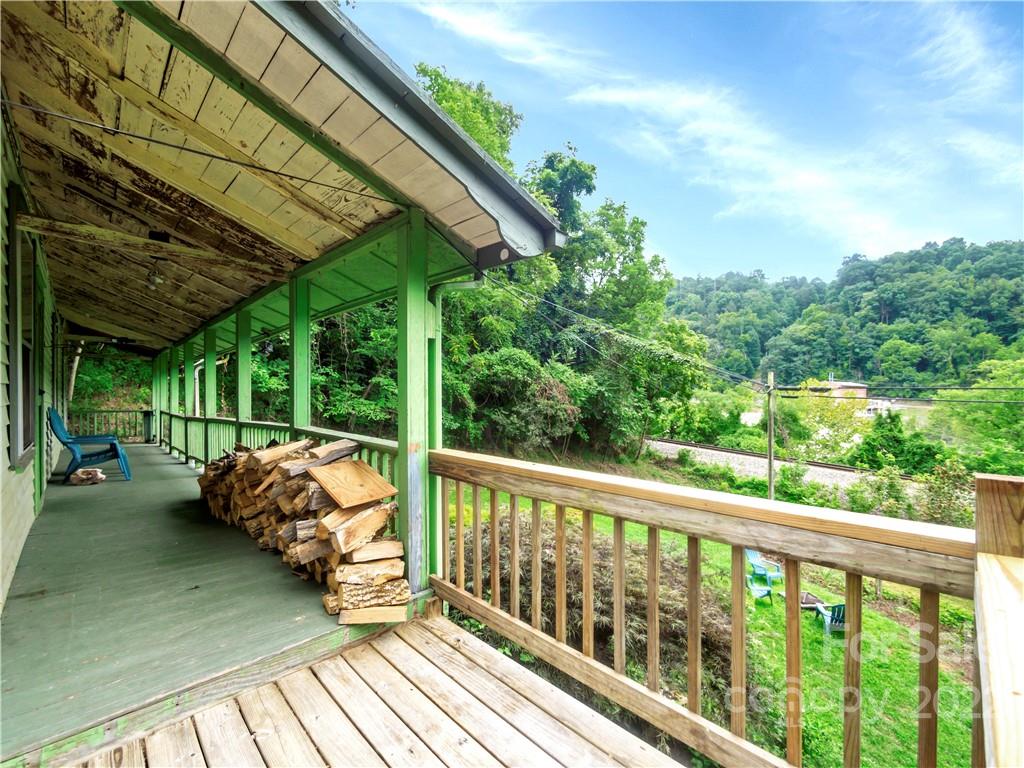 2731 Redmon Road Marshall, NC 28753 - Photo 8 of 43 a view of a wooden deck next to a yard