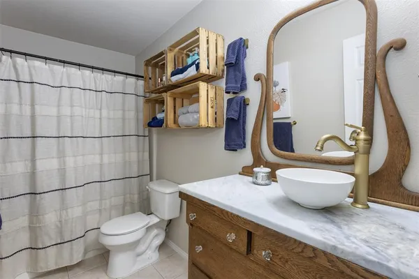 a bathroom with a toilet sink and shower