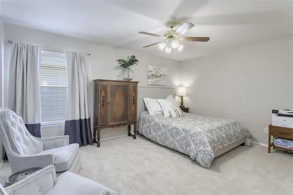 a bedroom with a bed and ceiling fan