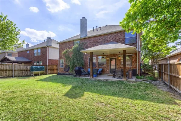 a view of a house with a yard and sitting area
