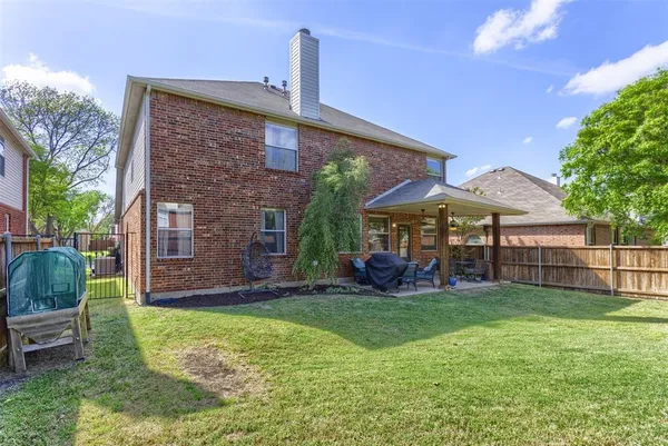 a view of a house with a yard and sitting area