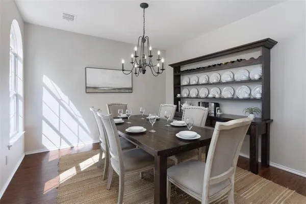 a view of a dining room with furniture wooden floor and chandelier