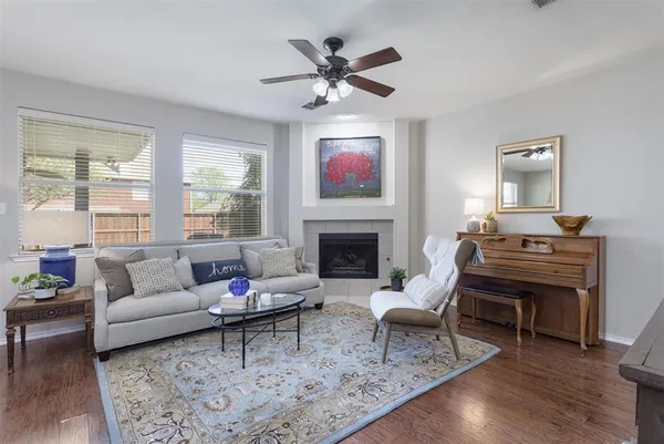 a living room with furniture a rug and a window