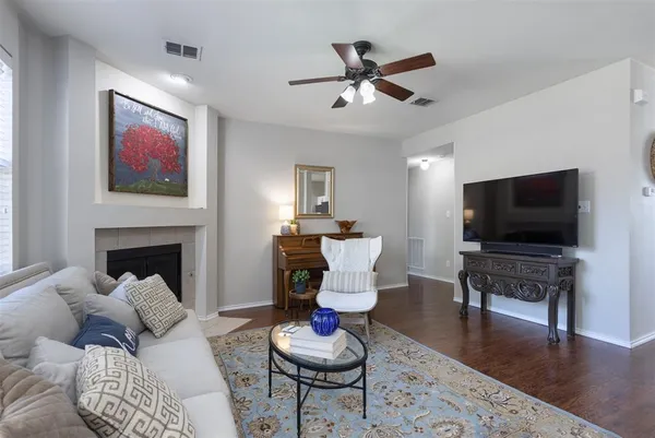 a living room with furniture a flat screen tv and kitchen view