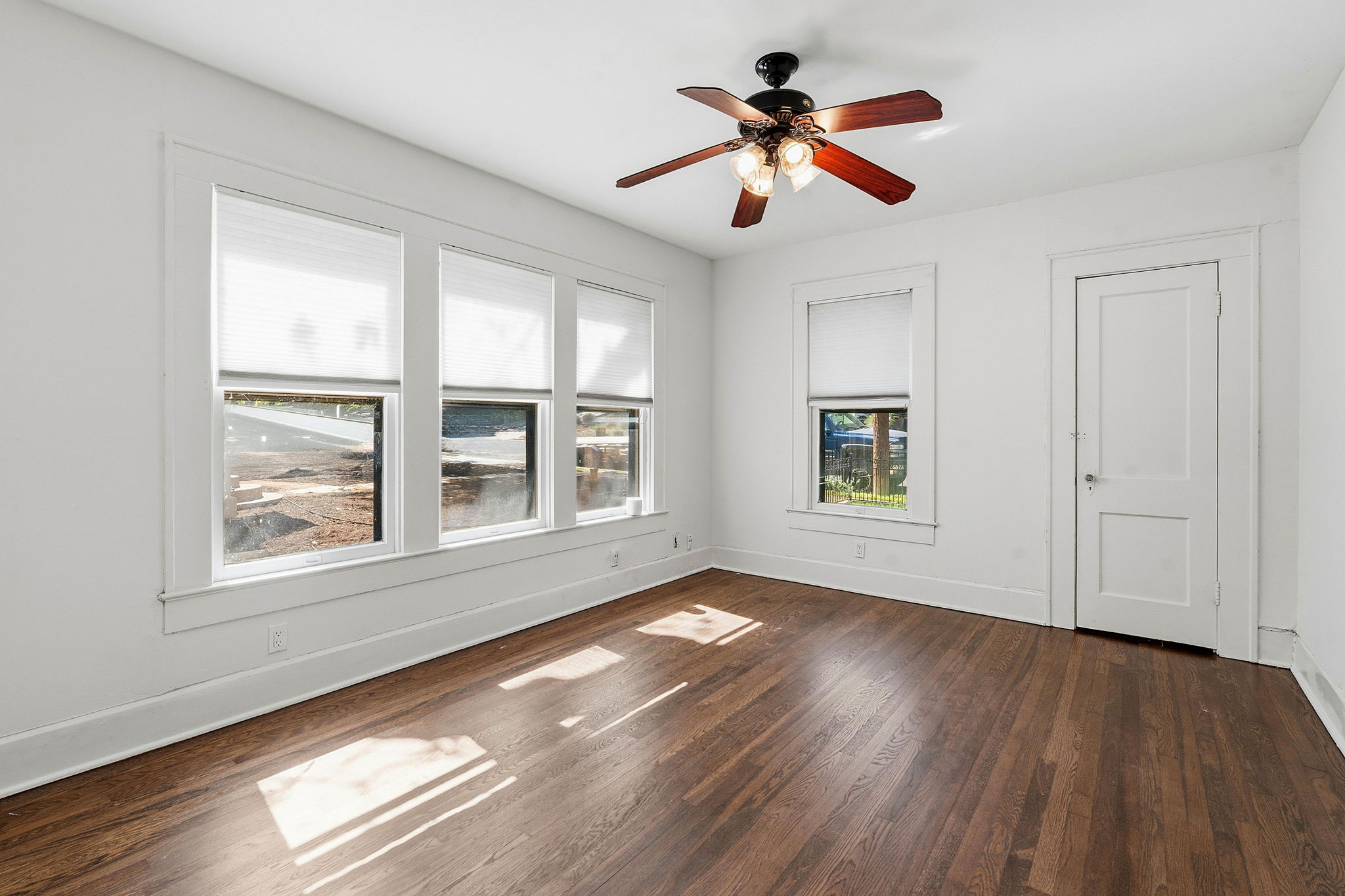 804 Rutherford Place, Unit A Austin, TX 78704 - Photo 11 of 17 a view of an empty room with wooden floor and a window