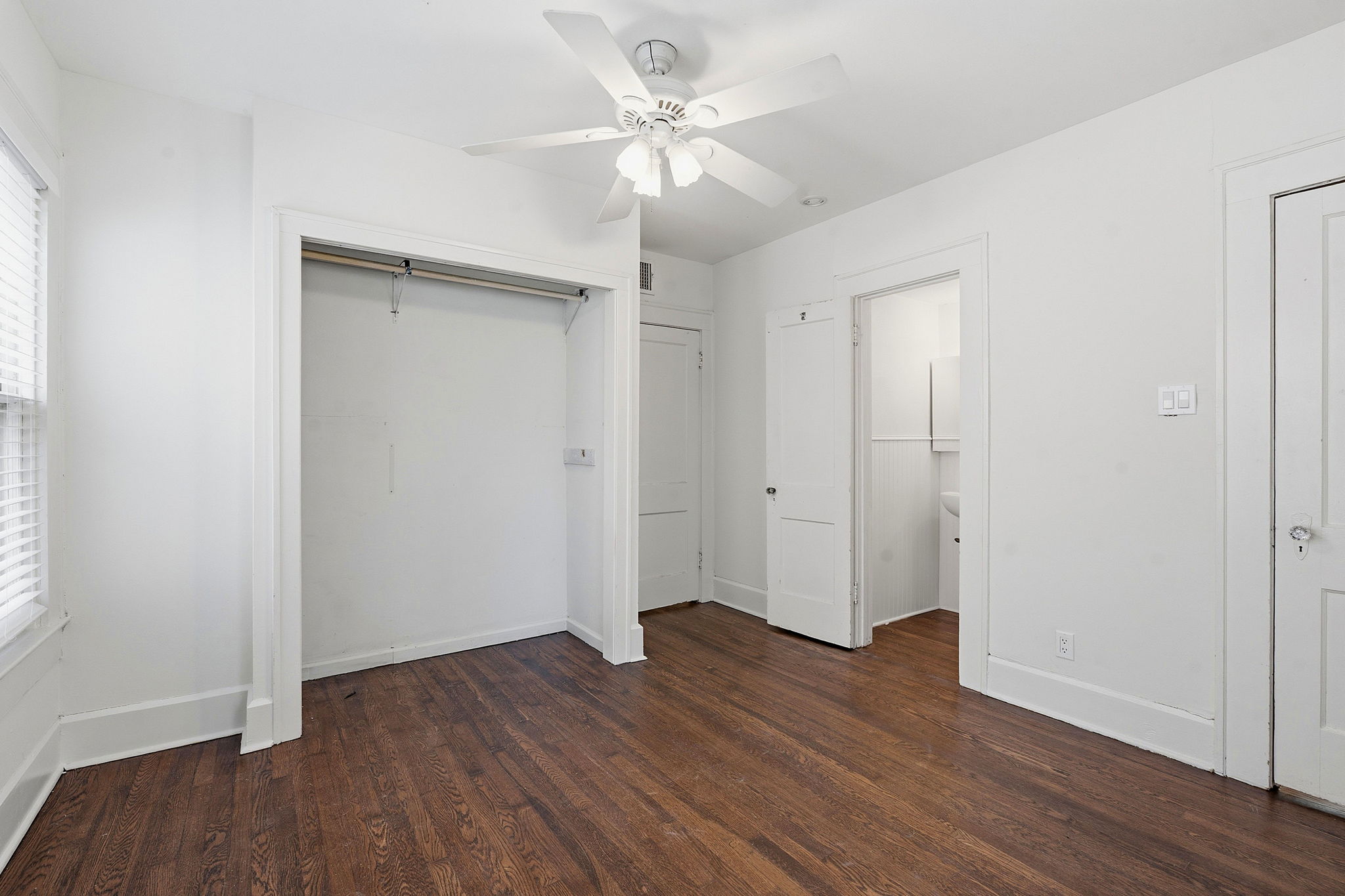 804 Rutherford Place, Unit A Austin, TX 78704 - Photo 15 of 17 an empty room with wooden floor and a ceiling fan