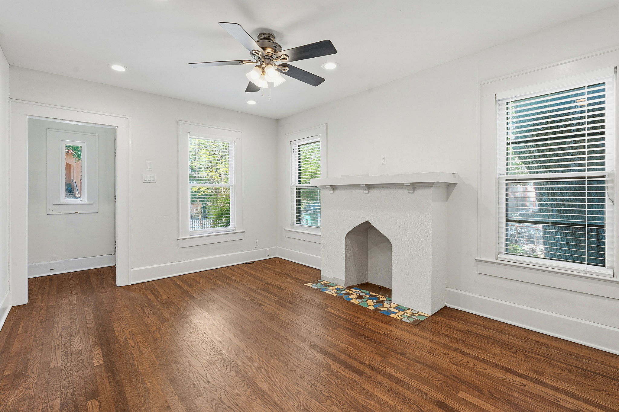 804 Rutherford Place, Unit A Austin, TX 78704 - Photo 3 of 17 a view of an empty room with wooden floor and a window