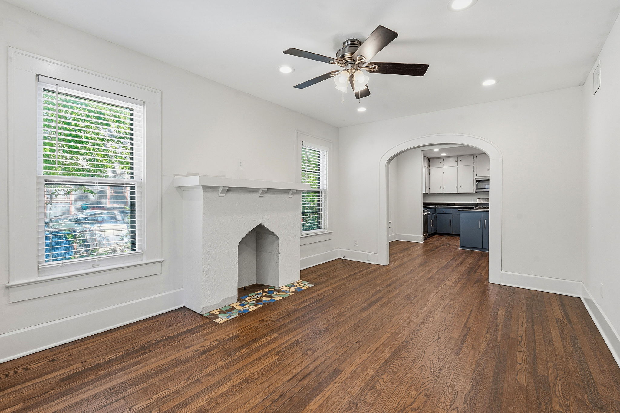 804 Rutherford Place, Unit A Austin, TX 78704 - Photo 4 of 17 an empty room with wooden floor fireplace and windows