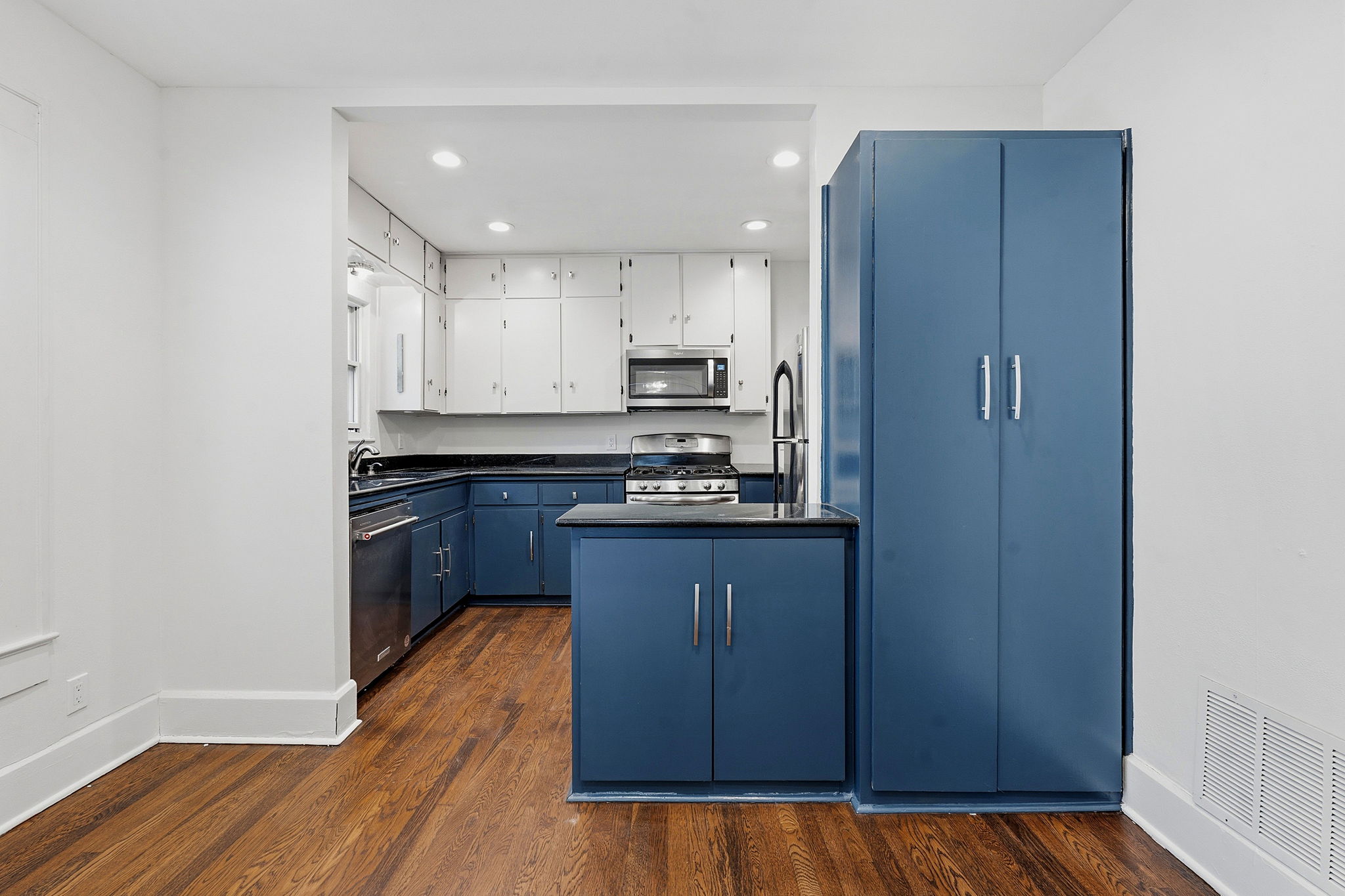 804 Rutherford Place, Unit A Austin, TX 78704 - Photo 6 of 17 a kitchen with kitchen island granite countertop wooden cabinets and a refrigerator