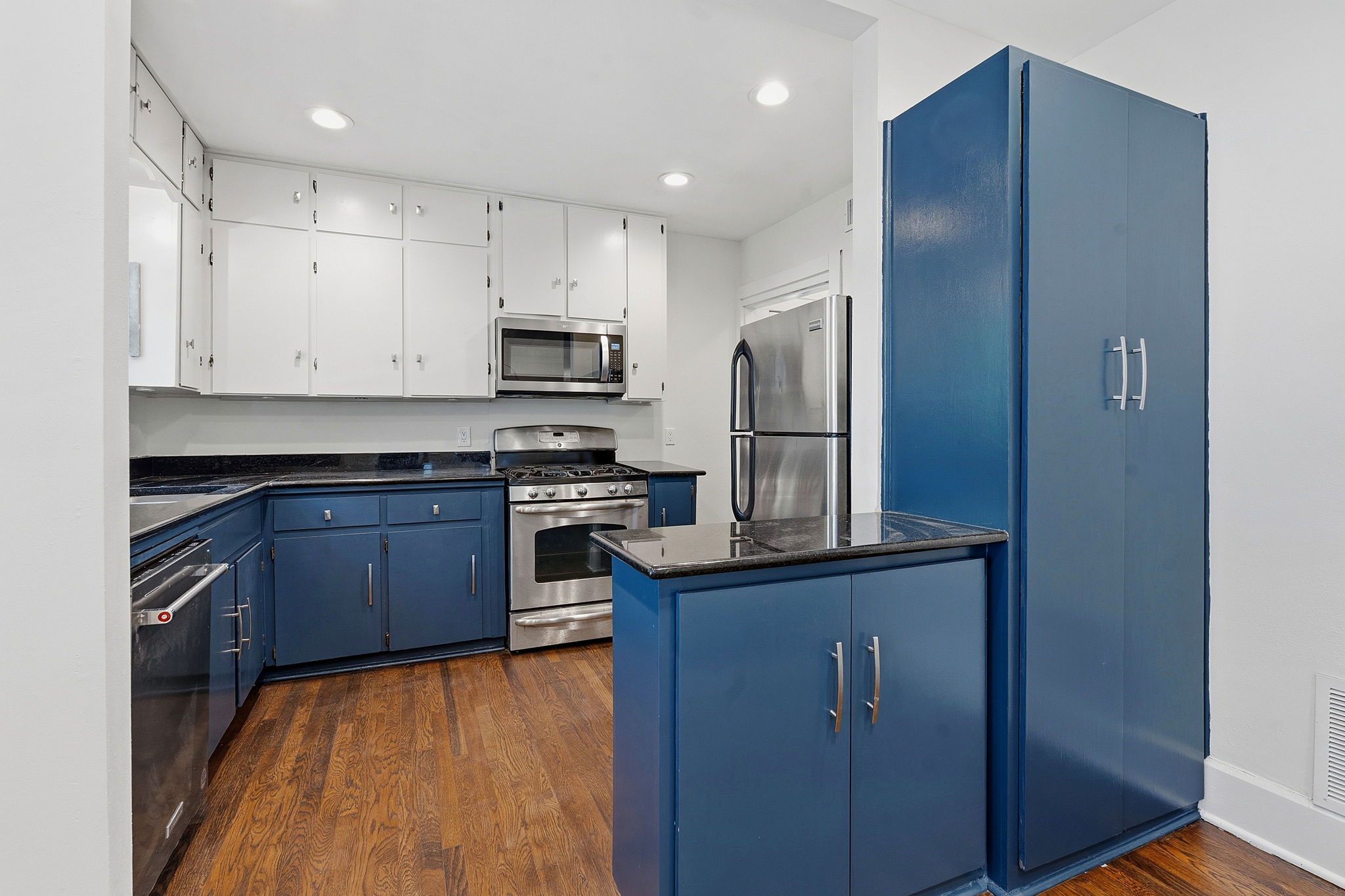804 Rutherford Place, Unit A Austin, TX 78704 - Photo 7 of 17 a kitchen with kitchen island granite countertop wooden cabinets and stainless steel appliances