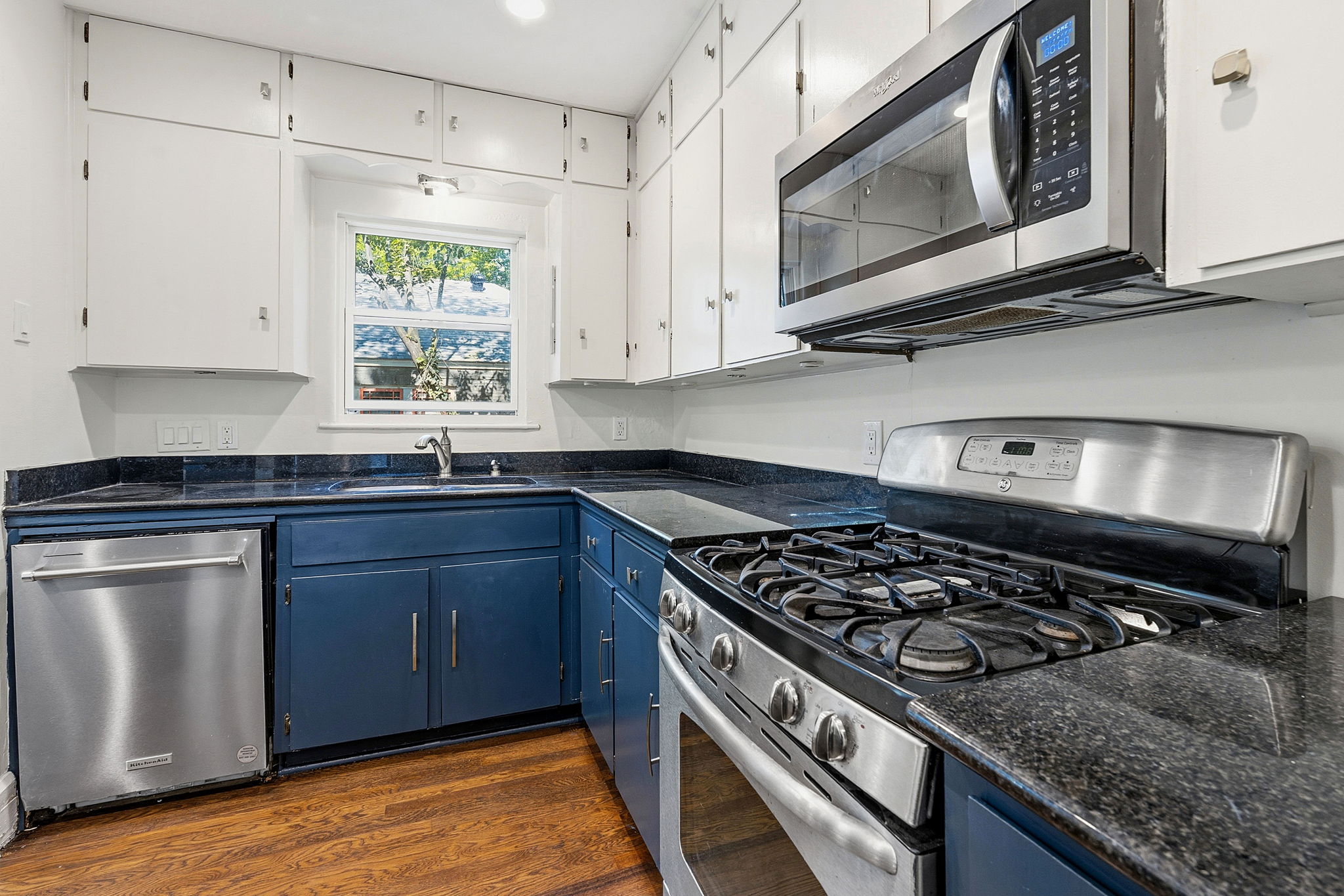 804 Rutherford Place, Unit A Austin, TX 78704 - Photo 9 of 17 a kitchen with stainless steel appliances granite countertop a stove and a microwave