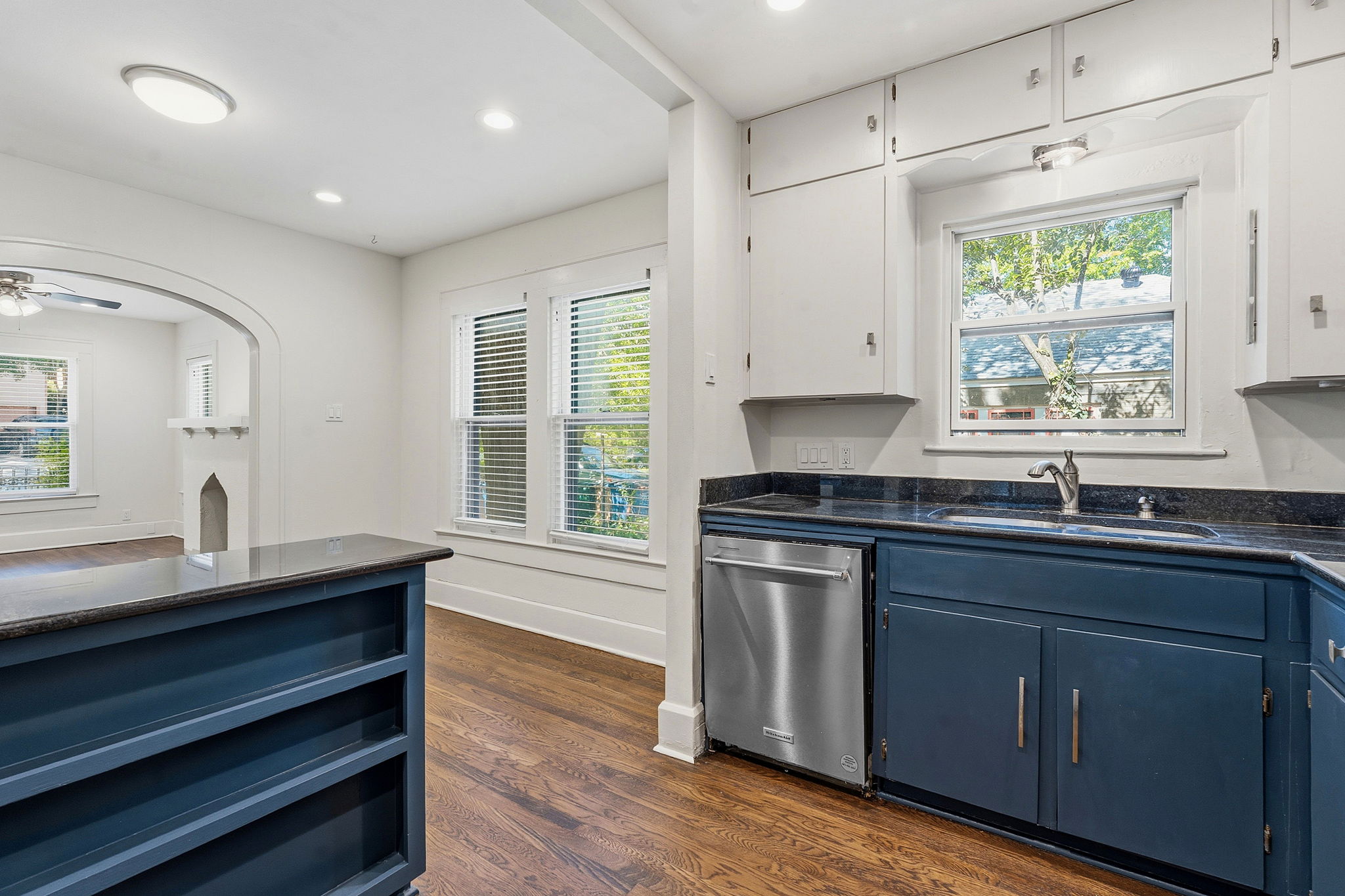 804 Rutherford Place, Unit A Austin, TX 78704 - Photo 10 of 17 a kitchen with granite countertop a sink cabinets stainless steel appliances and a window
