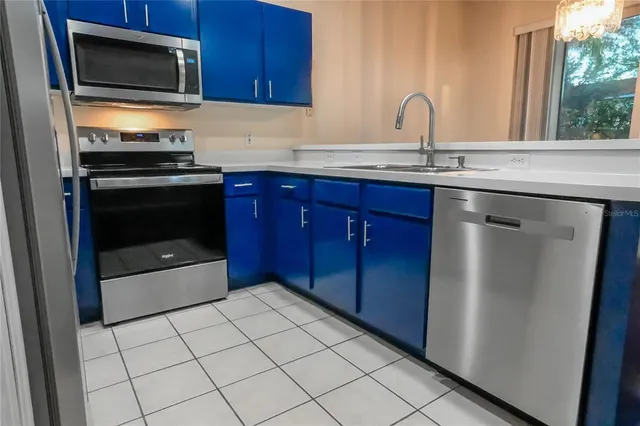 a kitchen with granite countertop a refrigerator and a stove