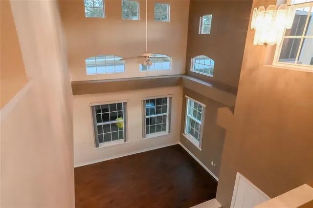 a view of a white house with a small yard and plants
