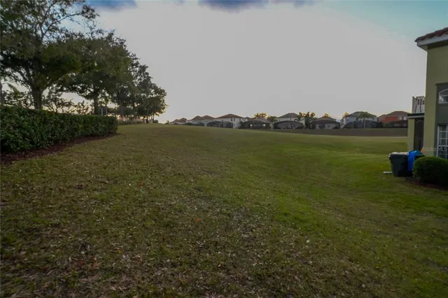 a view of a white house next to a yard