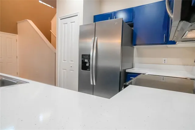a kitchen with refrigerator and window